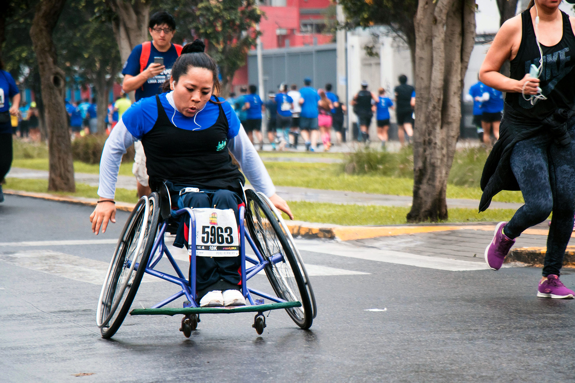 Woman racing in wheelchair.